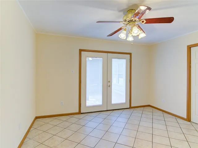 a view of house with deck outdoor seating and covered with trees