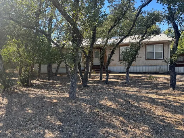 a view of a tree in front of a house