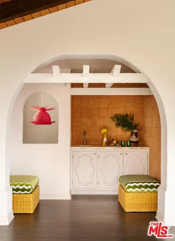 a living room with furniture a flat screen tv and balcony