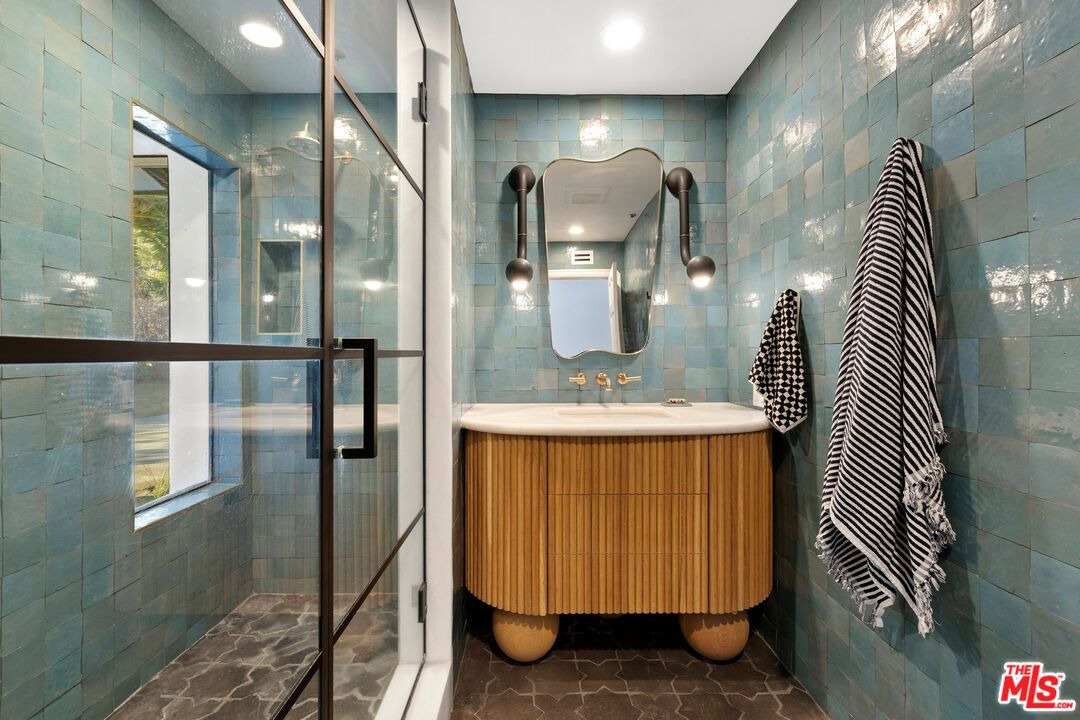 33261 Decker School Road Malibu, CA 90265 - Photo 23 of 32 a bathroom with a sink and mirror
