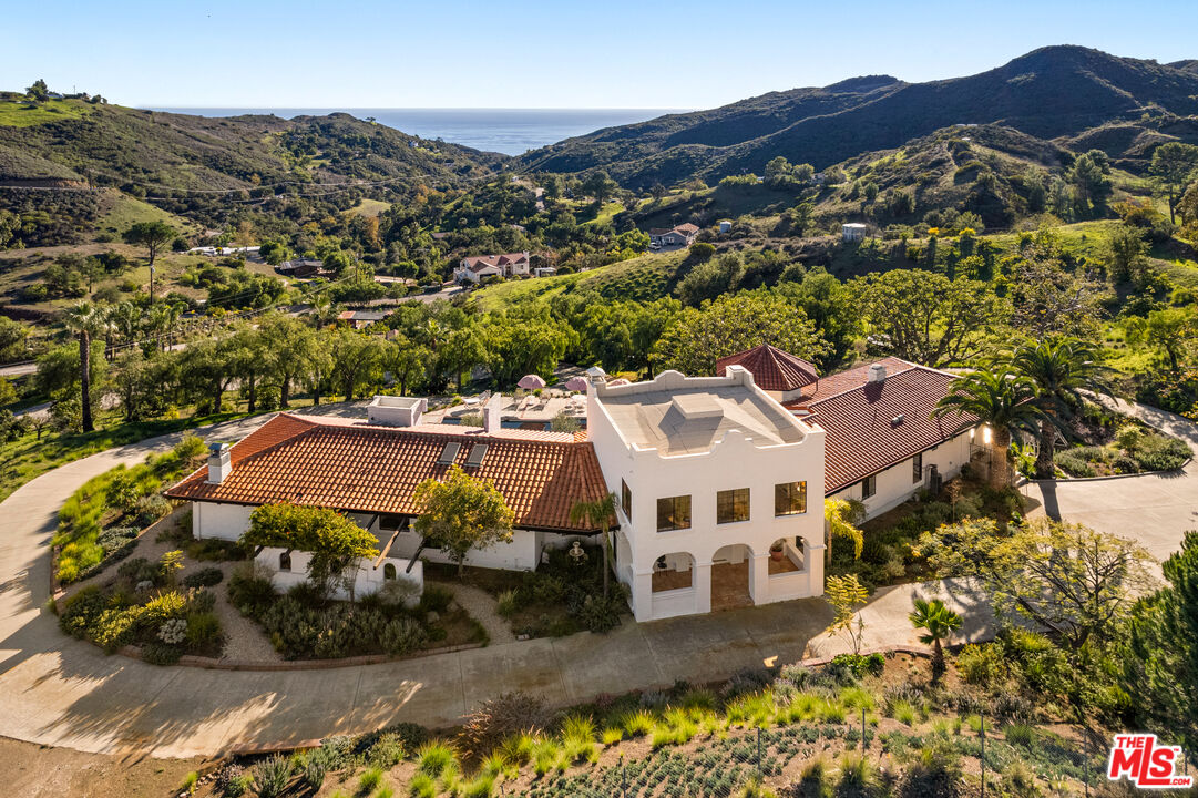 33261 Decker School Road Malibu, CA 90265 - Photo 3 of 32 a view of a white house with a mountain in the background