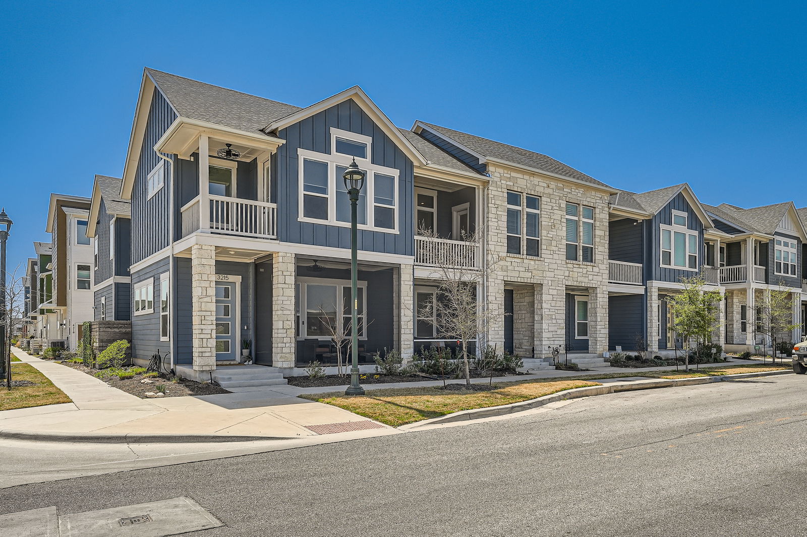 3213 Zach Scott Street Austin, TX 78723 - Photo 17 of 18 Craftsman house featuring board and batten siding, stone siding, a balcony, and a residential view