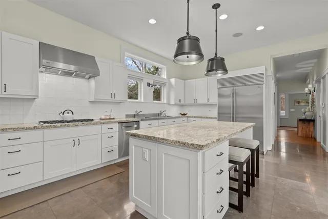 a view of a hallway with wooden floor and furniture
