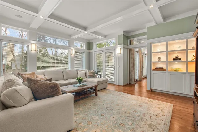 a dining room with furniture and wooden floor