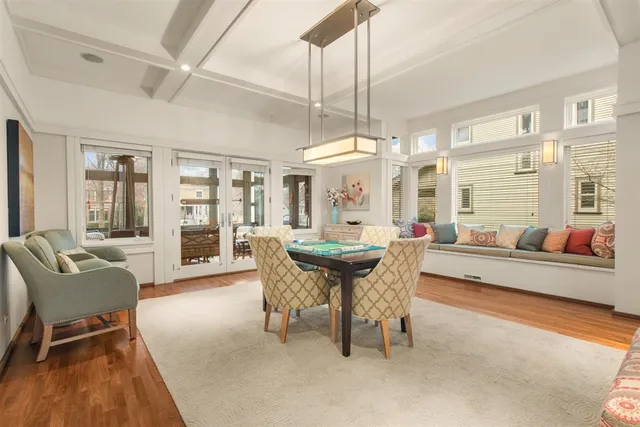 a bedroom with a bed a fireplace and a large window