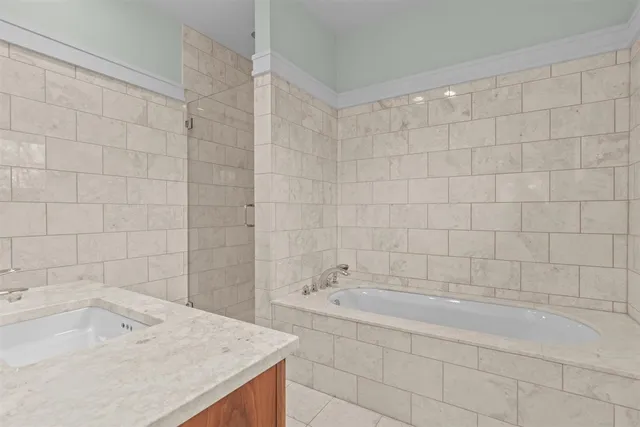 a bathroom with a granite countertop sink a toilet and shower