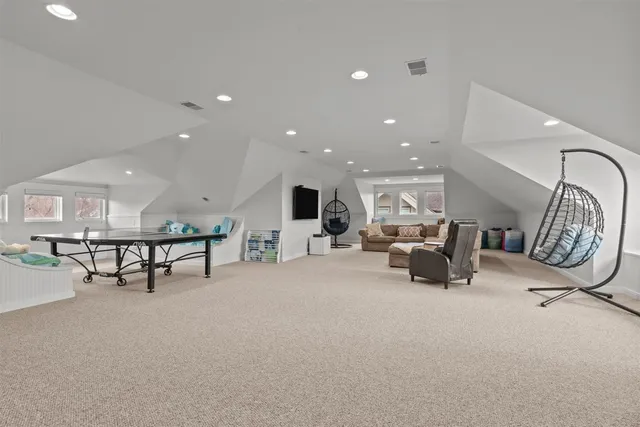 a living room with furniture a flat screen tv and a table