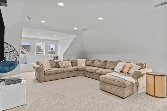 a view of backyard with outdoor seating and trees