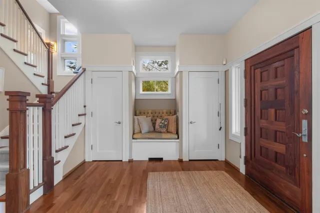 a view of entryway with wooden floor and stairs