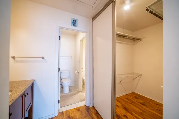 a view of an empty room with wooden floor