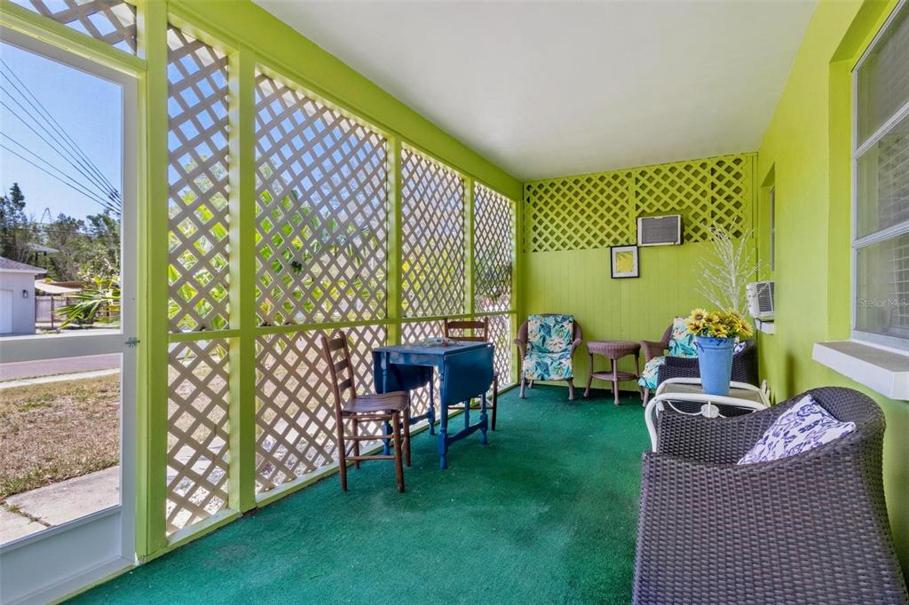 504 Milwaukee Avenue, Unit A Dunedin, FL 34698 - Photo 12 of 27 a balcony with chairs and a table