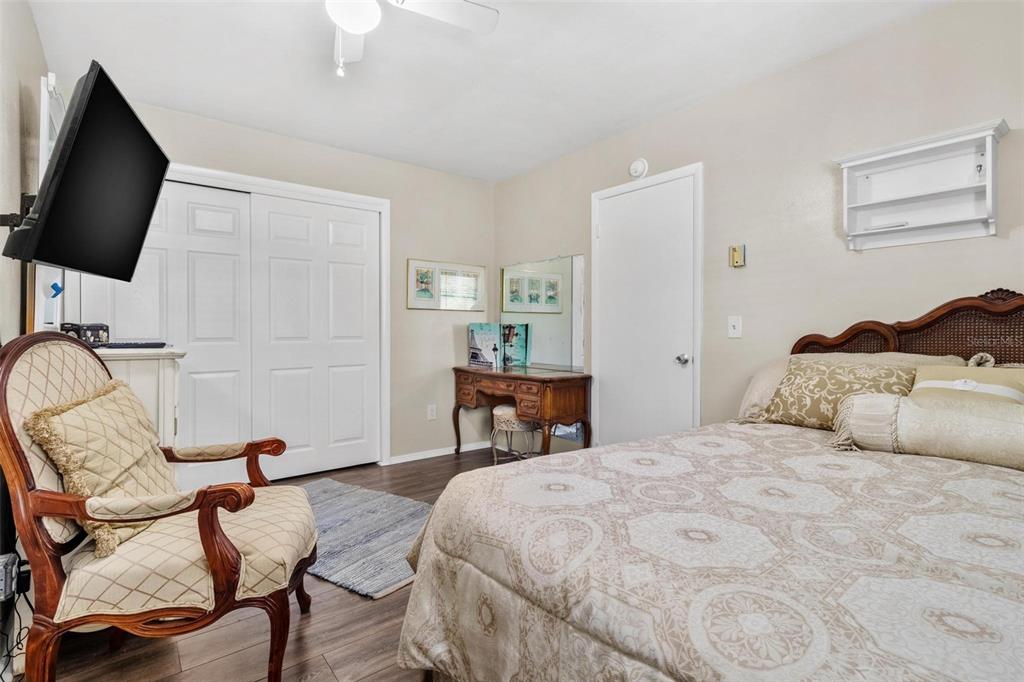 504 Milwaukee Avenue, Unit A Dunedin, FL 34698 - Photo 14 of 27 a bedroom with a bed and a flat screen tv