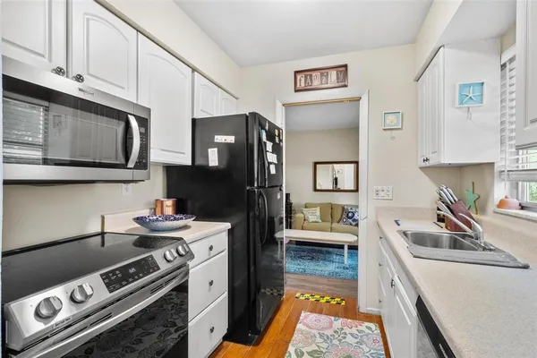 a kitchen with stainless steel appliances granite countertop a stove and a sink