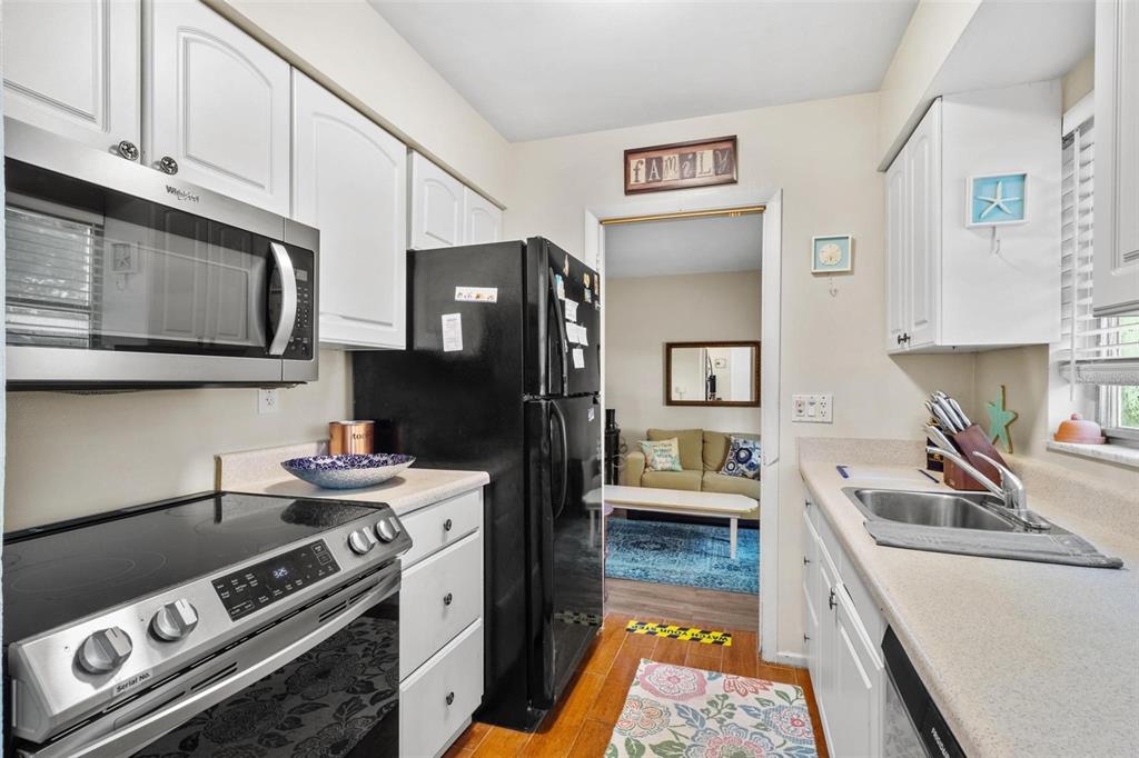 504 Milwaukee Avenue, Unit A Dunedin, FL 34698 - Photo 2 of 27 a kitchen with stainless steel appliances granite countertop a stove and a sink