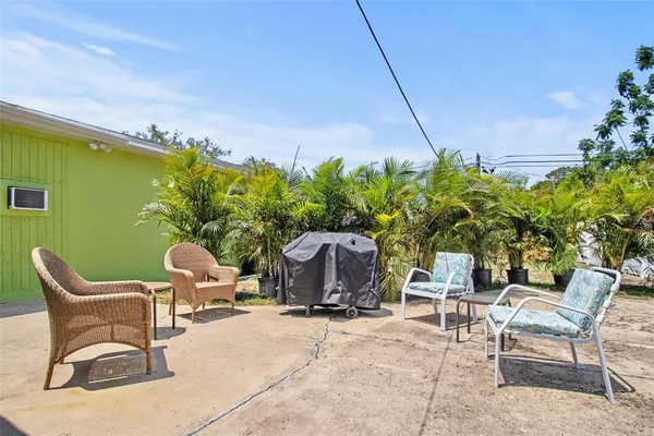 a backyard of a house with table and chairs