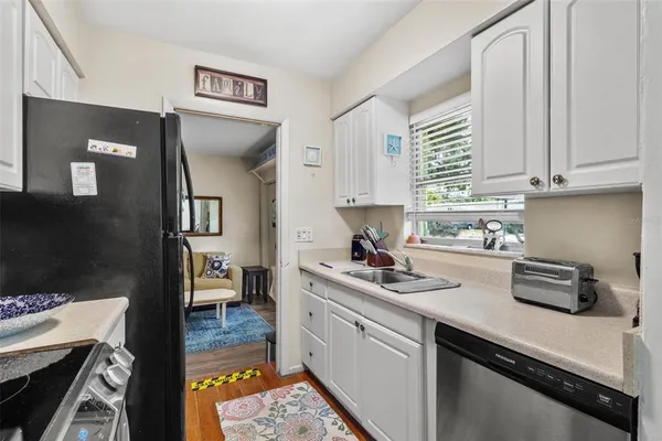 a kitchen with a sink stove and cabinets