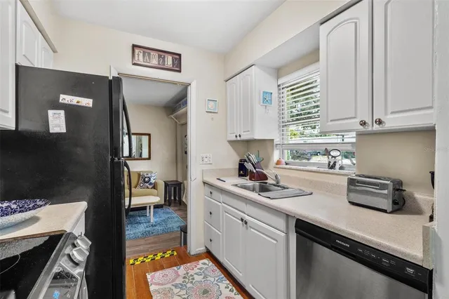 a kitchen with a sink stove and cabinets