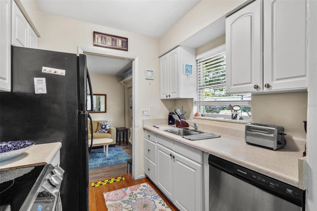 504 Milwaukee Avenue, Unit A Dunedin, FL 34698 - Photo 3 of 27 a kitchen with a sink stove and cabinets