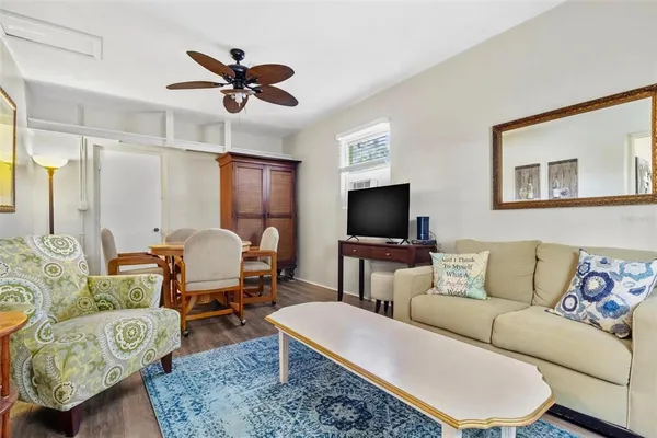 a living room with furniture a rug and a flat screen tv