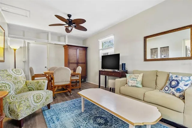 a living room with furniture a rug and a flat screen tv