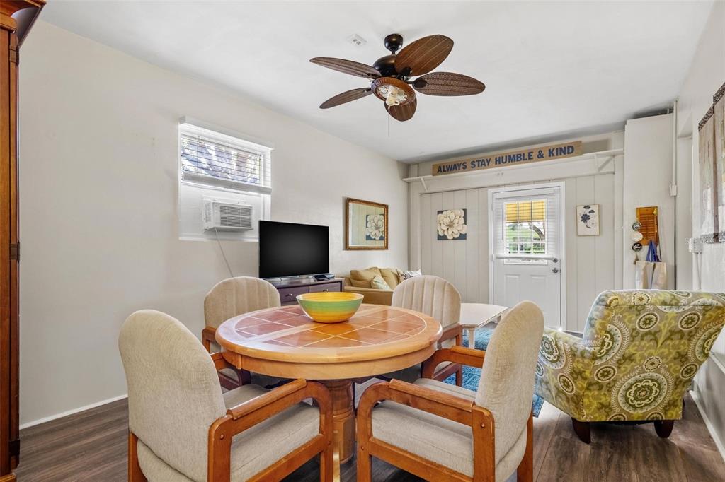 504 Milwaukee Avenue, Unit A Dunedin, FL 34698 - Photo 7 of 27 a view of a dining room with furniture and wooden floor