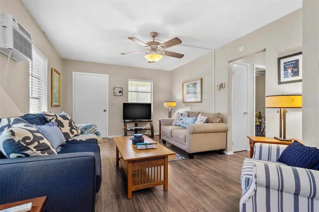 504 Milwaukee Avenue, Unit A Dunedin, FL 34698 - Photo 9 of 27 a living room with furniture and a flat screen tv