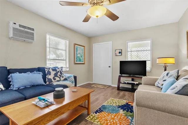 a living room with furniture a rug and a flat screen tv