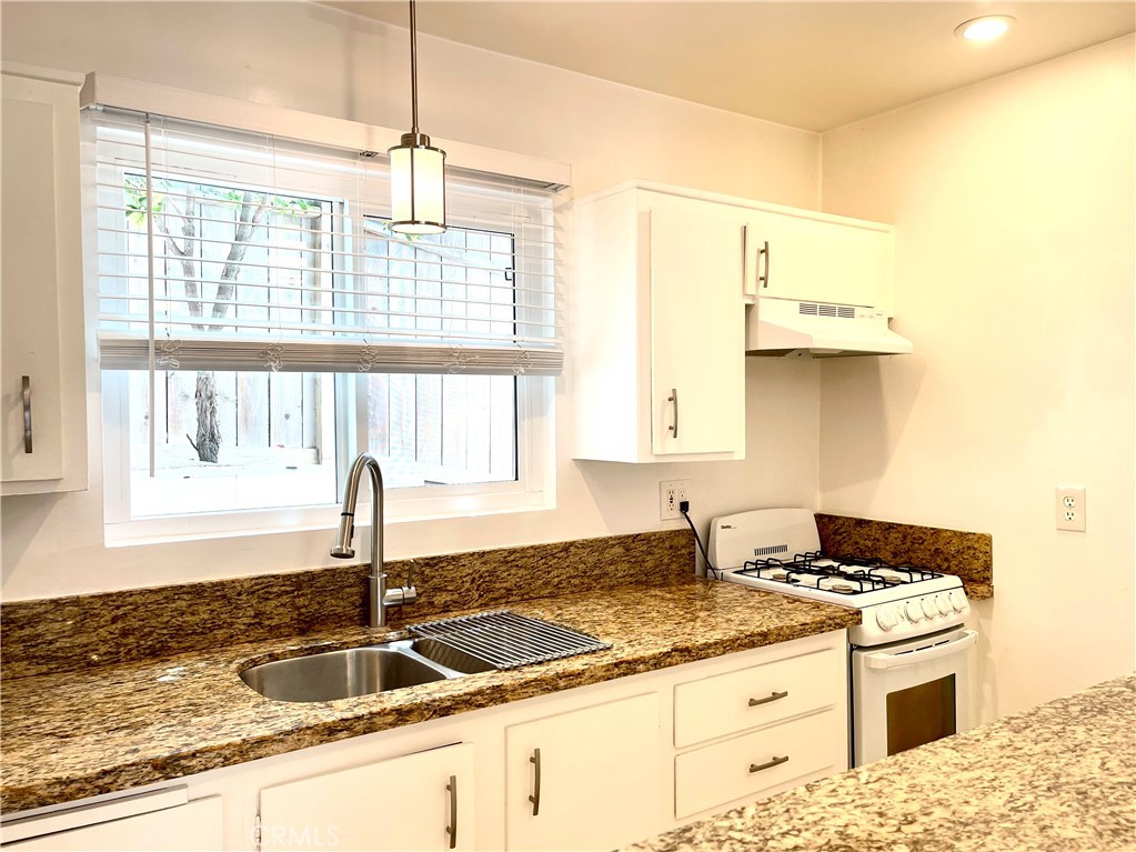 25091 La Cresta Drive Dana Point, CA 92629 - Photo 5 of 13 a kitchen with granite countertop a sink stove and cabinets