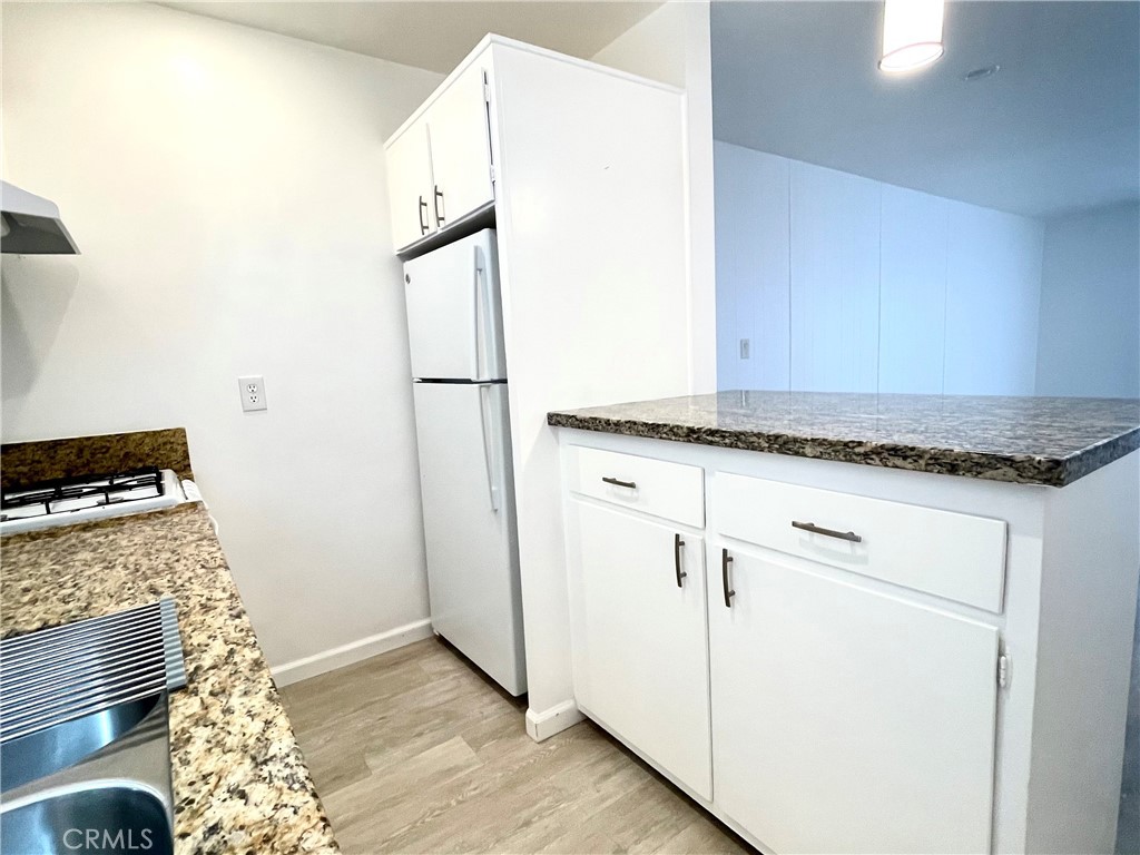 25091 La Cresta Drive Dana Point, CA 92629 - Photo 6 of 13 a kitchen with granite countertop cabinets and black appliances