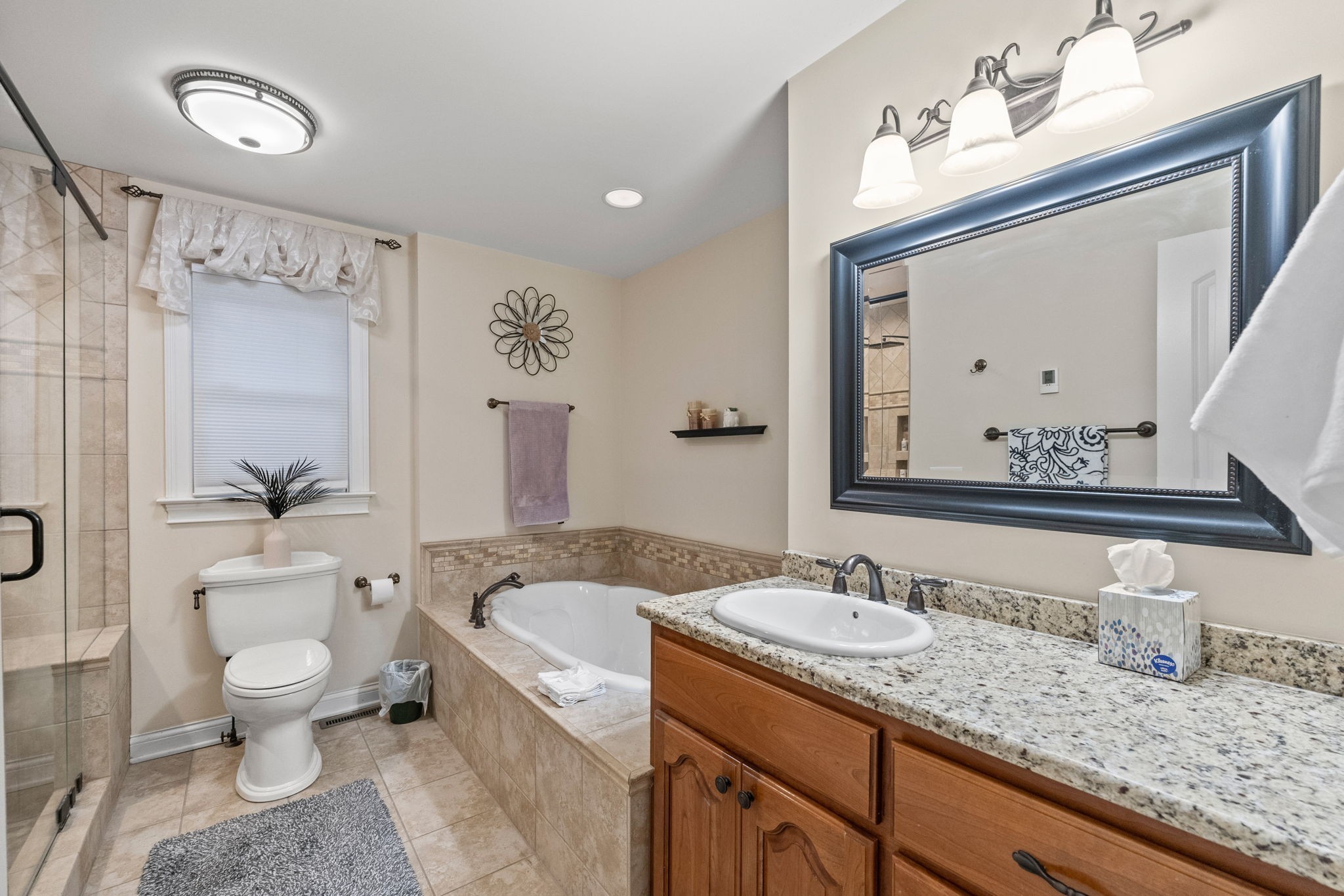 612 Fairway Trail Springfield, TN 37172 - Photo 17 of 50 a bathroom with a granite countertop sink mirror vanity bathtub and a toilet