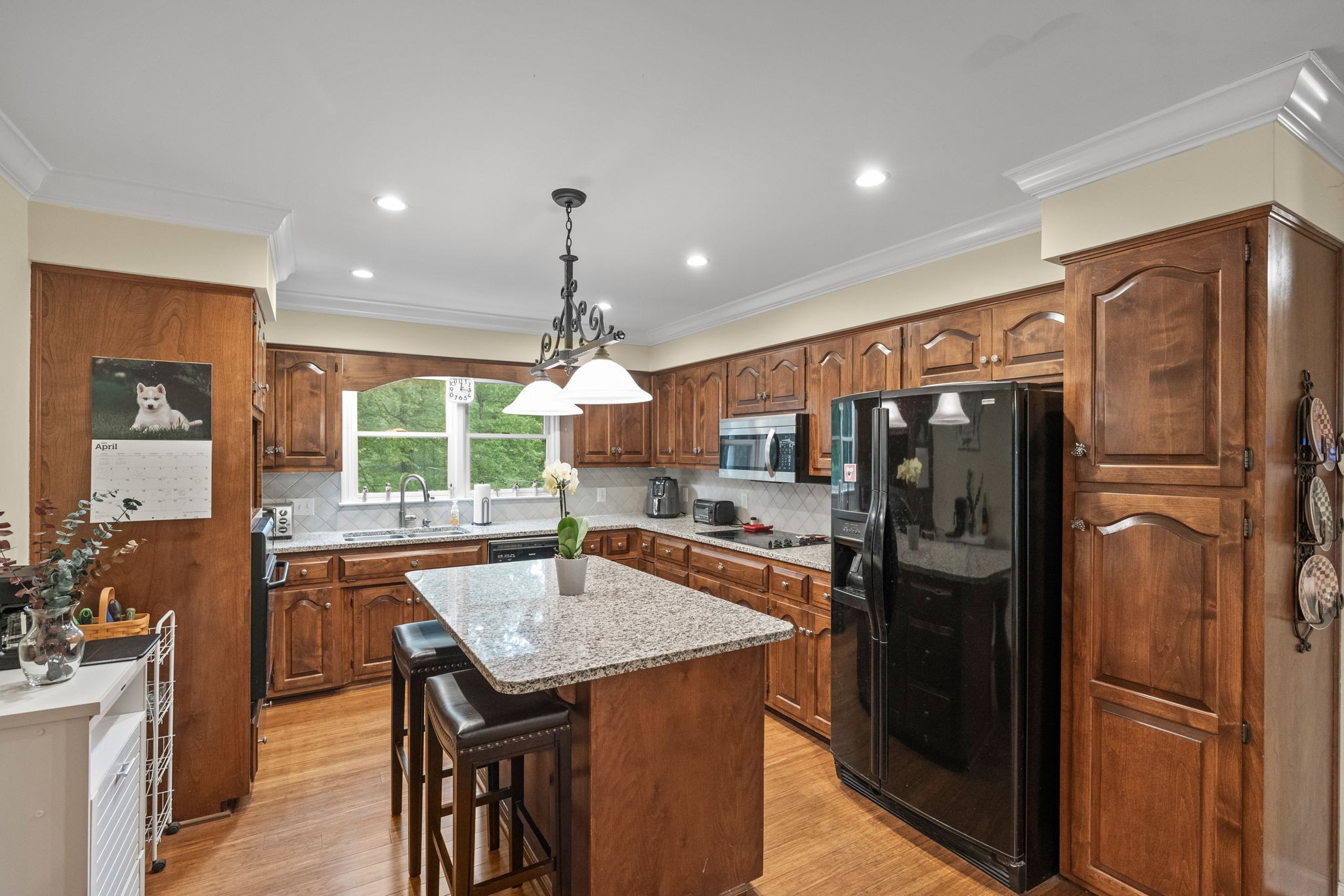 612 Fairway Trail Springfield, TN 37172 - Photo 34 of 50 a kitchen with stainless steel appliances granite countertop a refrigerator a sink a stove a dining table and chairs