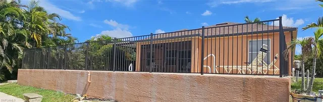 a view of a house with a wooden fence