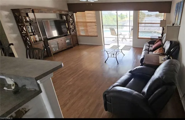a view of a dining room with furniture window and wooden floor