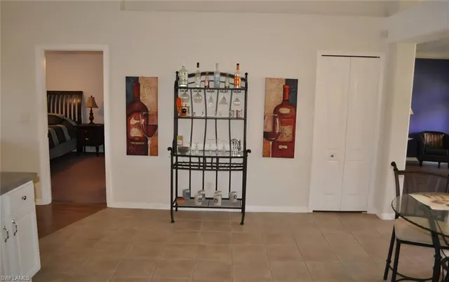 a kitchen with stainless steel appliances granite countertop a stove top oven a sink a refrigerator and white cabinets