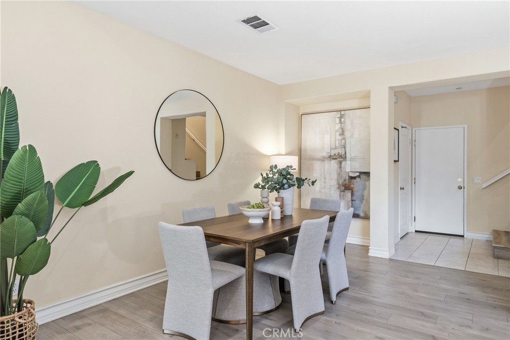 123 Chantilly Irvine, CA 92620 - Photo 11 of 31 a dining room with furniture potted plants and wooden floor