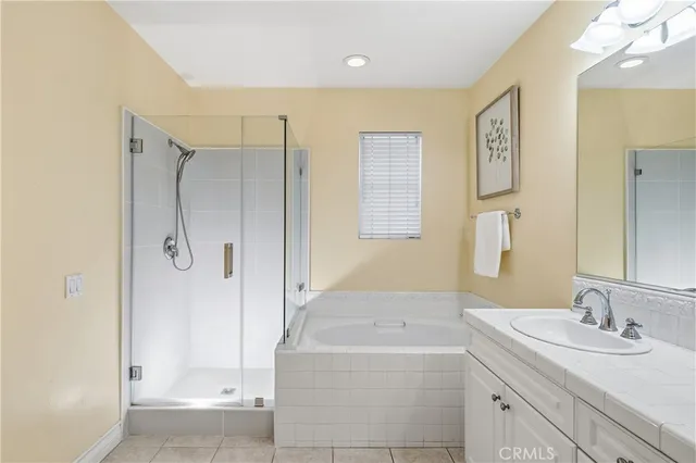 a bathroom with a granite countertop sink a shower and a mirror