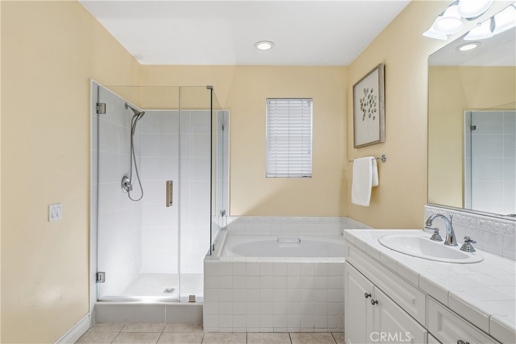 123 Chantilly Irvine, CA 92620 - Photo 21 of 31 a bathroom with a granite countertop sink a shower and a mirror