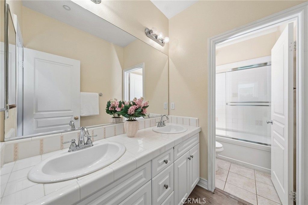 123 Chantilly Irvine, CA 92620 - Photo 24 of 31 a bathroom with a sink and a mirror