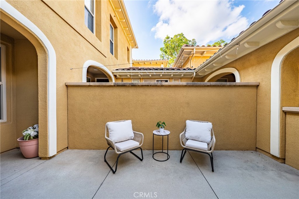 123 Chantilly Irvine, CA 92620 - Photo 26 of 31 a view of a chair and fire pit in front of a door