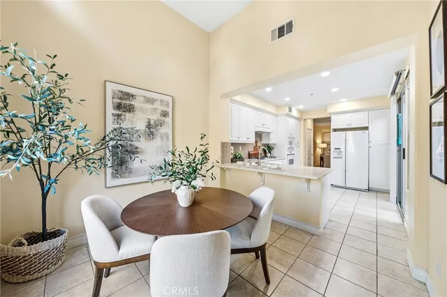 a dining room with furniture and a potted plant