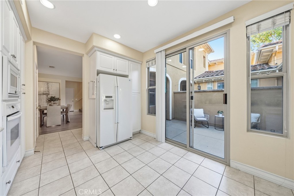 123 Chantilly Irvine, CA 92620 - Photo 7 of 31 a view of a kitchen with refrigerator and wooden floor