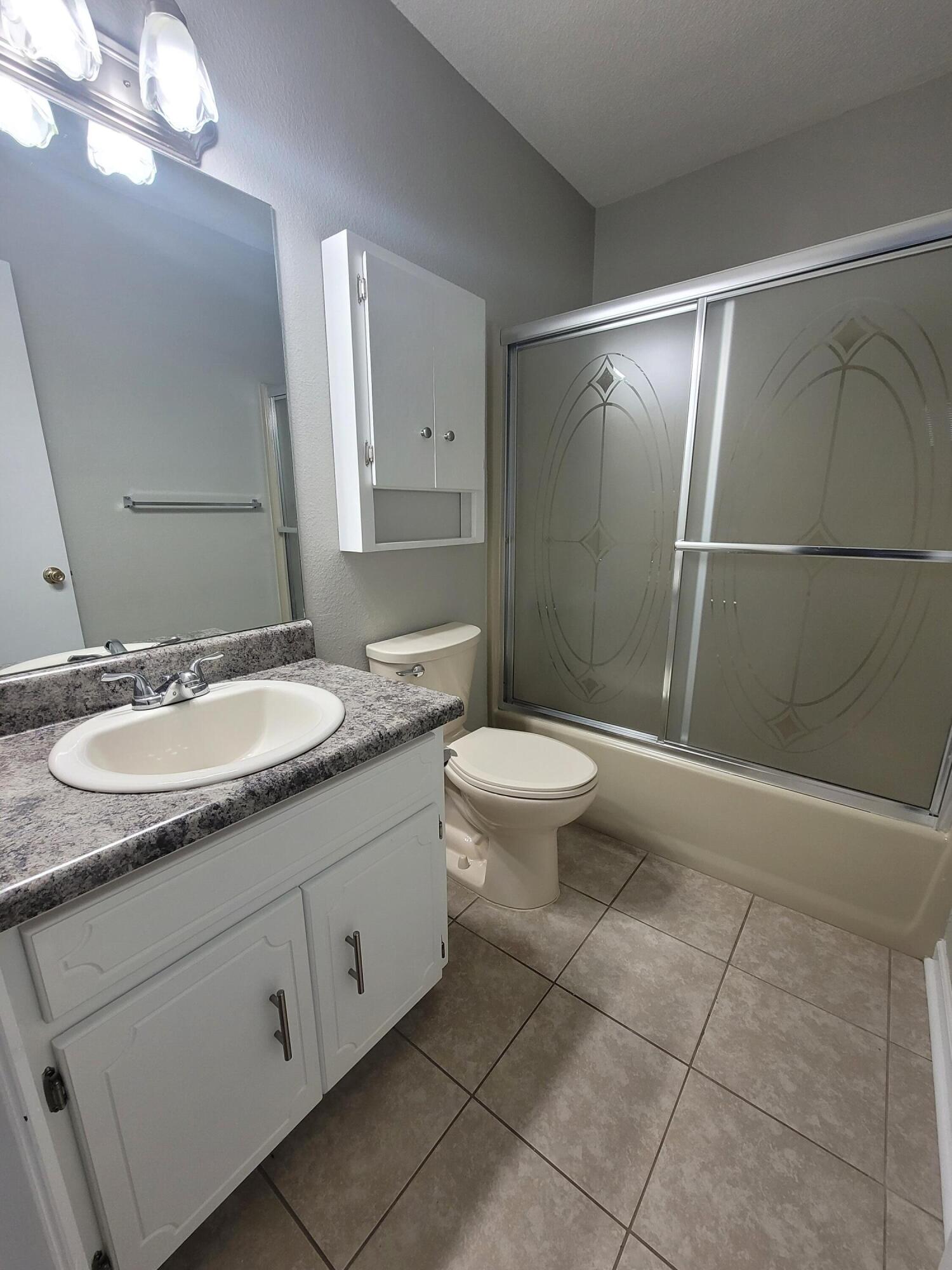 5496 Monterrey Road Crestview, FL 32539 - Photo 13 of 15 a bathroom with a sink a toilet and shower