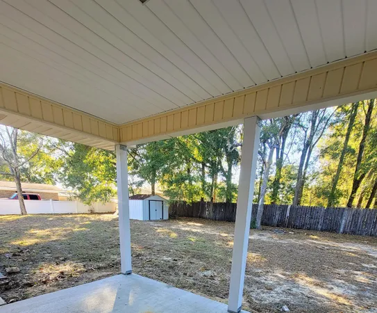 a view of a porch with furniture and garden