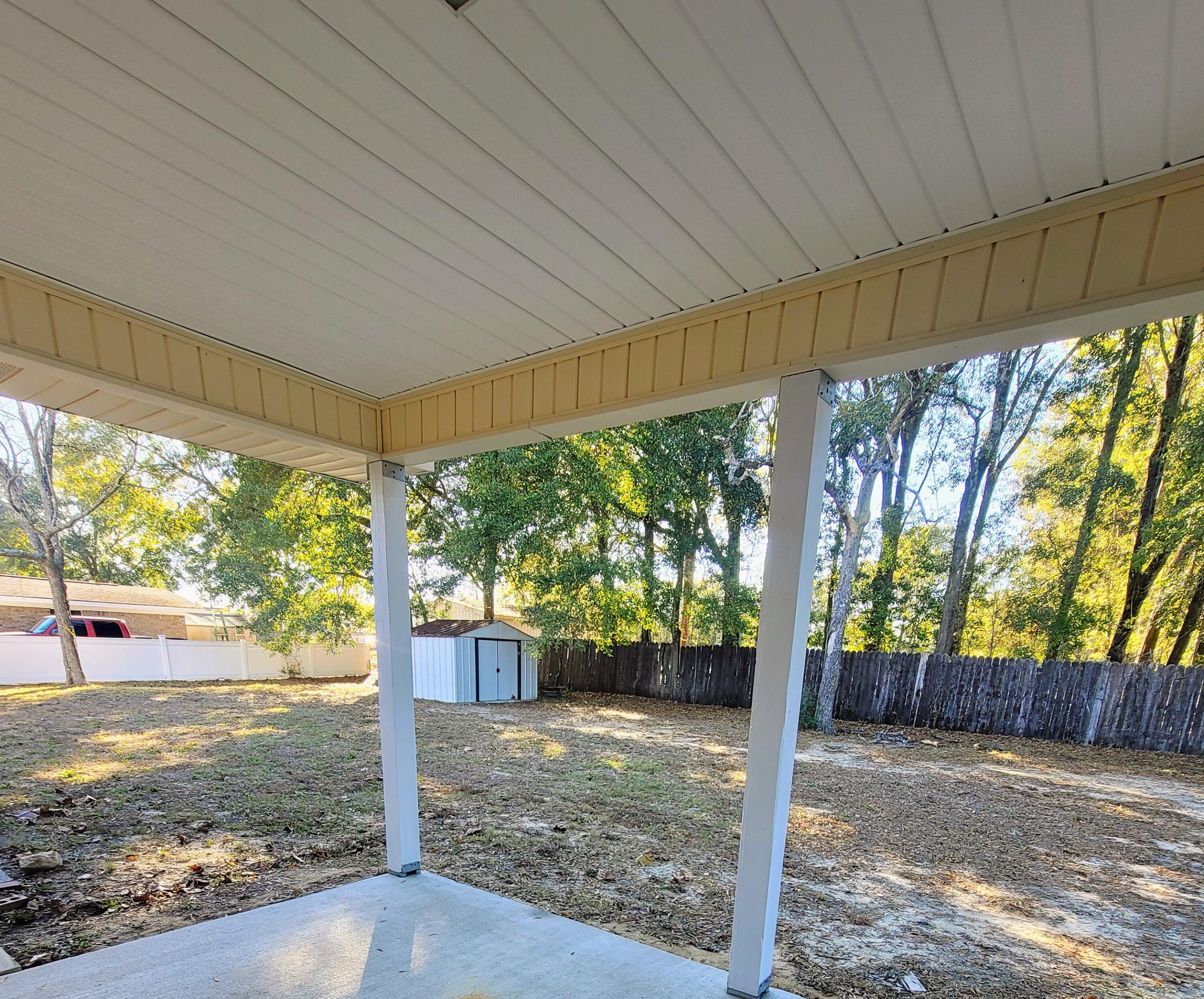 5496 Monterrey Road Crestview, FL 32539 - Photo 15 of 15 a view of a porch with furniture and garden