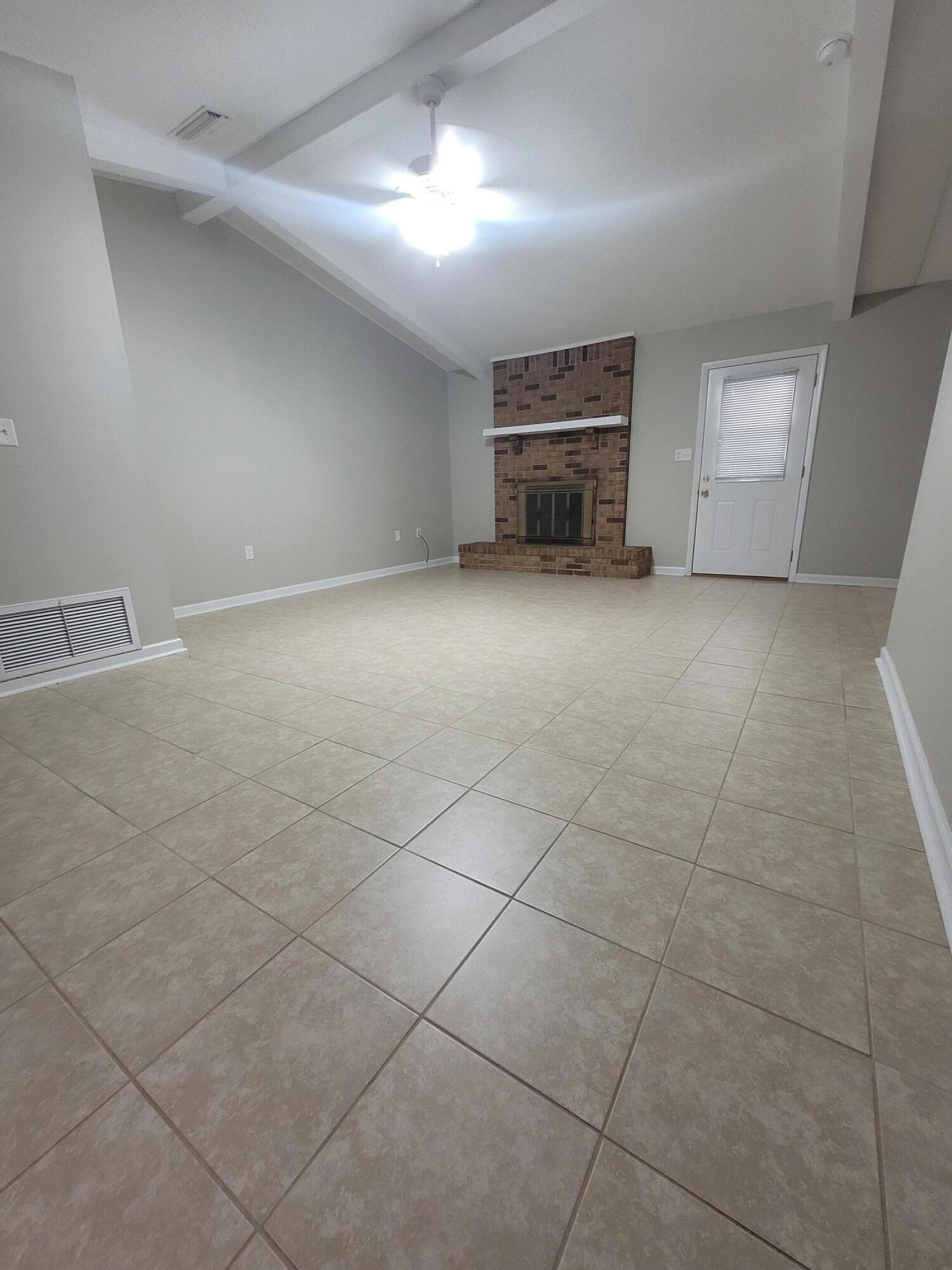 5496 Monterrey Road Crestview, FL 32539 - Photo 2 of 15 a view of empty room with a fireplace