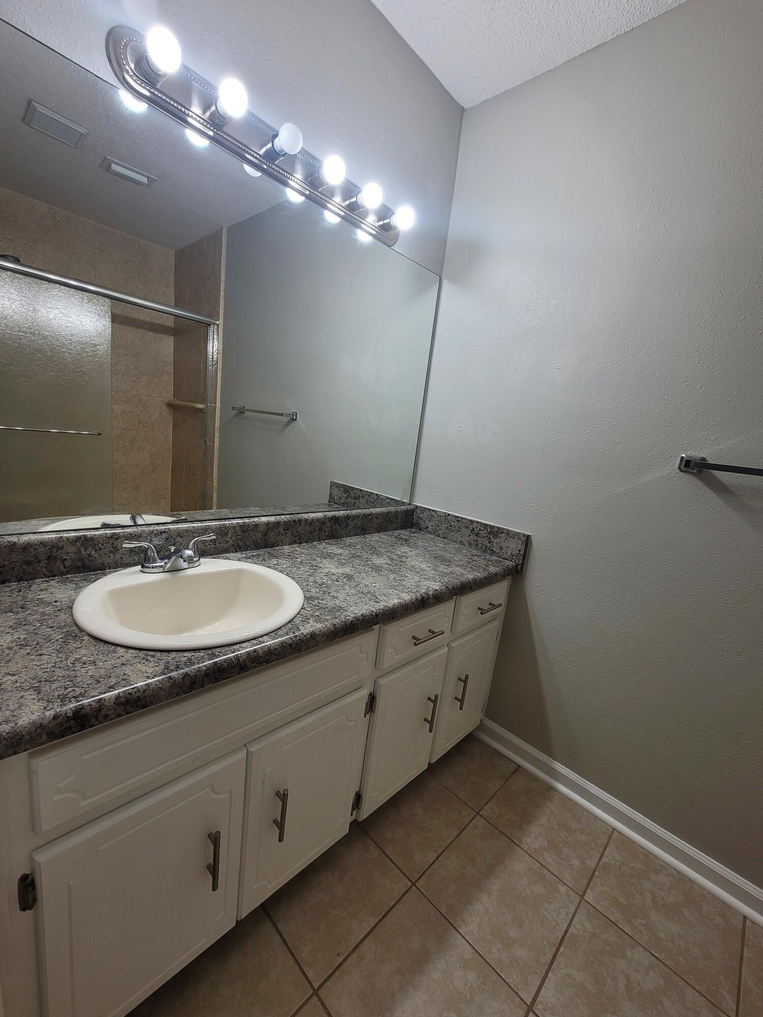 5496 Monterrey Road Crestview, FL 32539 - Photo 10 of 15 a bathroom with a sink and a mirror