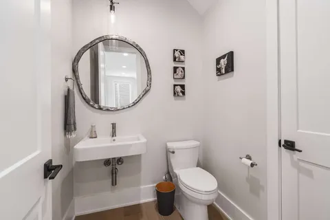 a spacious bedroom with a bed and wooden floor