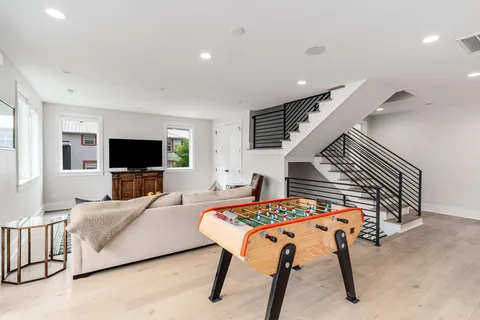 a roof deck with wooden floor and seating space