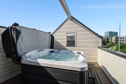 a view of a house with a yard and a large tree
