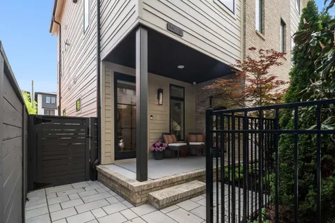 a view of a house with a yard and sitting area